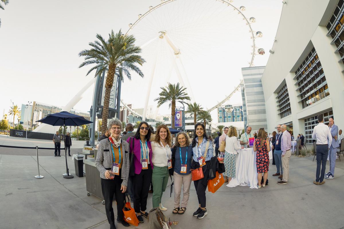 Attendees outside at a reception. 