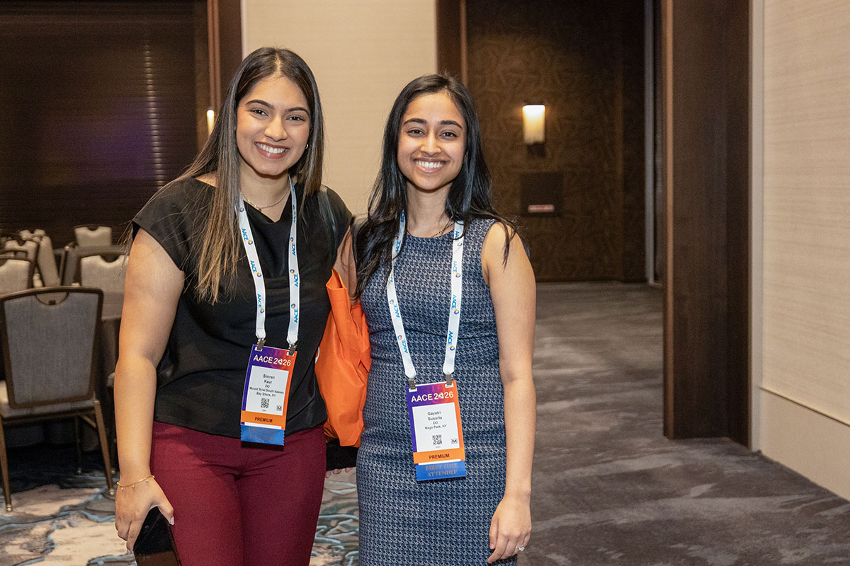 Two attendees posing for a photo together. 