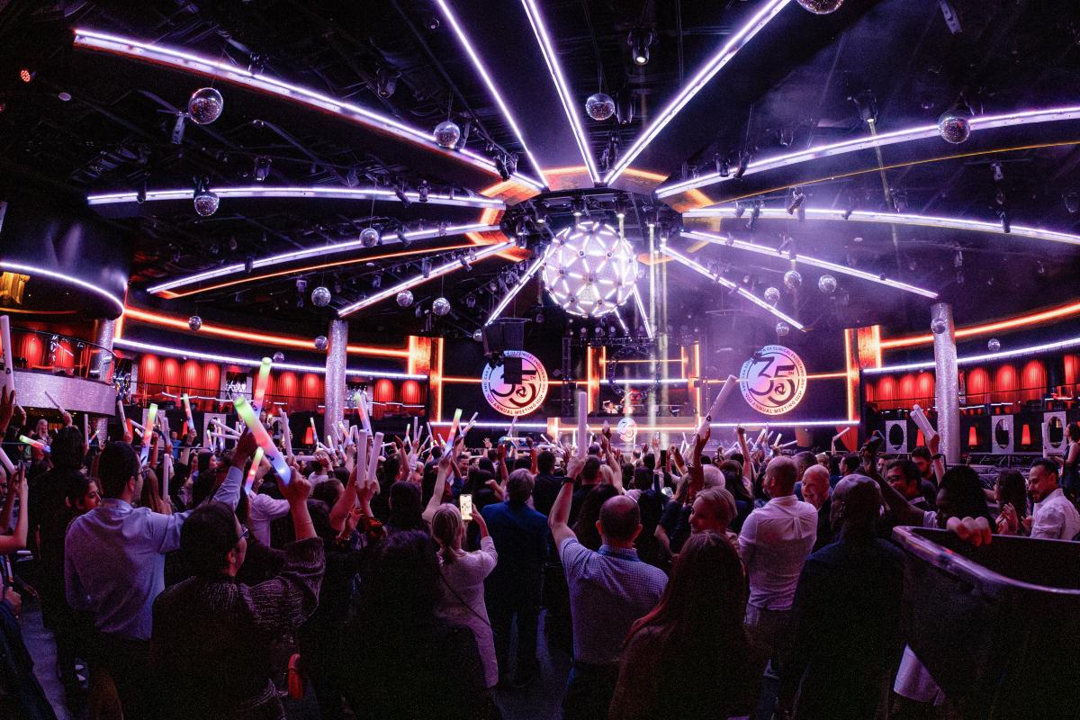 Attendees dancing at nightclub. 