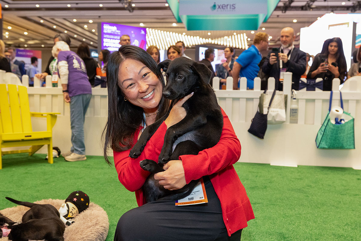 Attendee holding a puppy in the Puppy Park. 