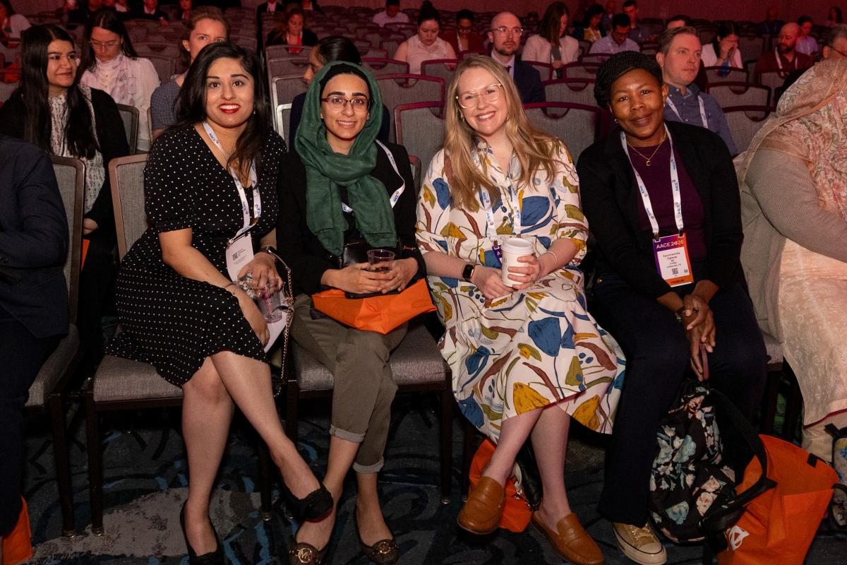 4 attendees sitting in audience 